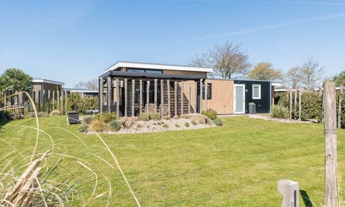 Burgh-Haamstede House | This chalet is beautifully finished both inside and outside. The landscaping, canopy, poster walls a