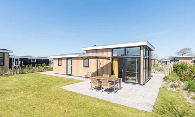 Burgh-Haamstede House | This modern 4-person chalet is located on a spacious plot on the edge of the park. Through the slidi