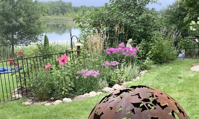 Howell House | Tranquil haven with a roomy deck and stunning panoramic lake views.