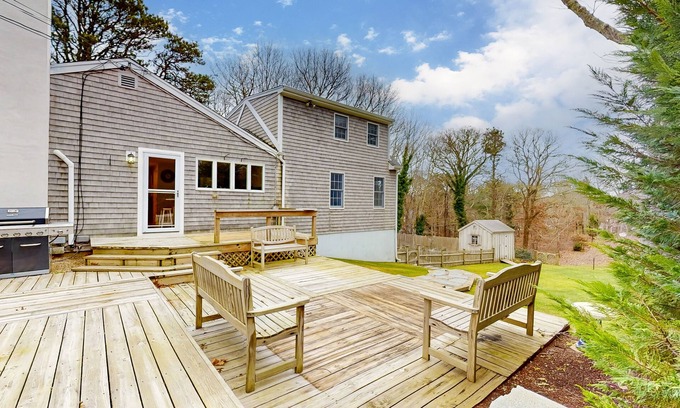 East Orleans House | Tranquil & sunlit home with peaceful yard, large deck, & fireplace - near beach
