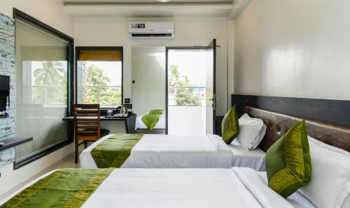 Nigdi Hotel | Treebo Malhaar Regency