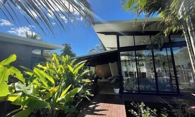Mission Beach House | Tropical Modernist Retreat is set up as a contemporary beach abode