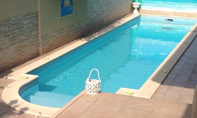 Pogliano Milanese Villa | Villa Le Tre Palme . Suite in relax . immersed in the green garden with swimming pool