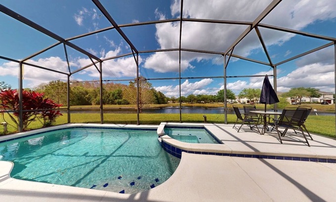 Trafalgar Village House | Water view retreat with lanai, heated pool, pool spa, game room, & AC