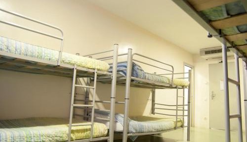 One bed in an 8-bed shared dormitory