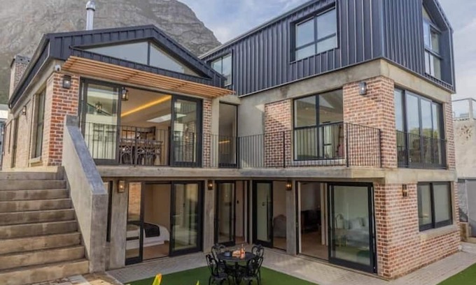 Voelklip House | Trendy family home, bright, mountain views & pool